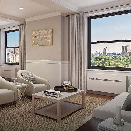 An apartment living room with two INNOVA units below windows overlooking Central Park
