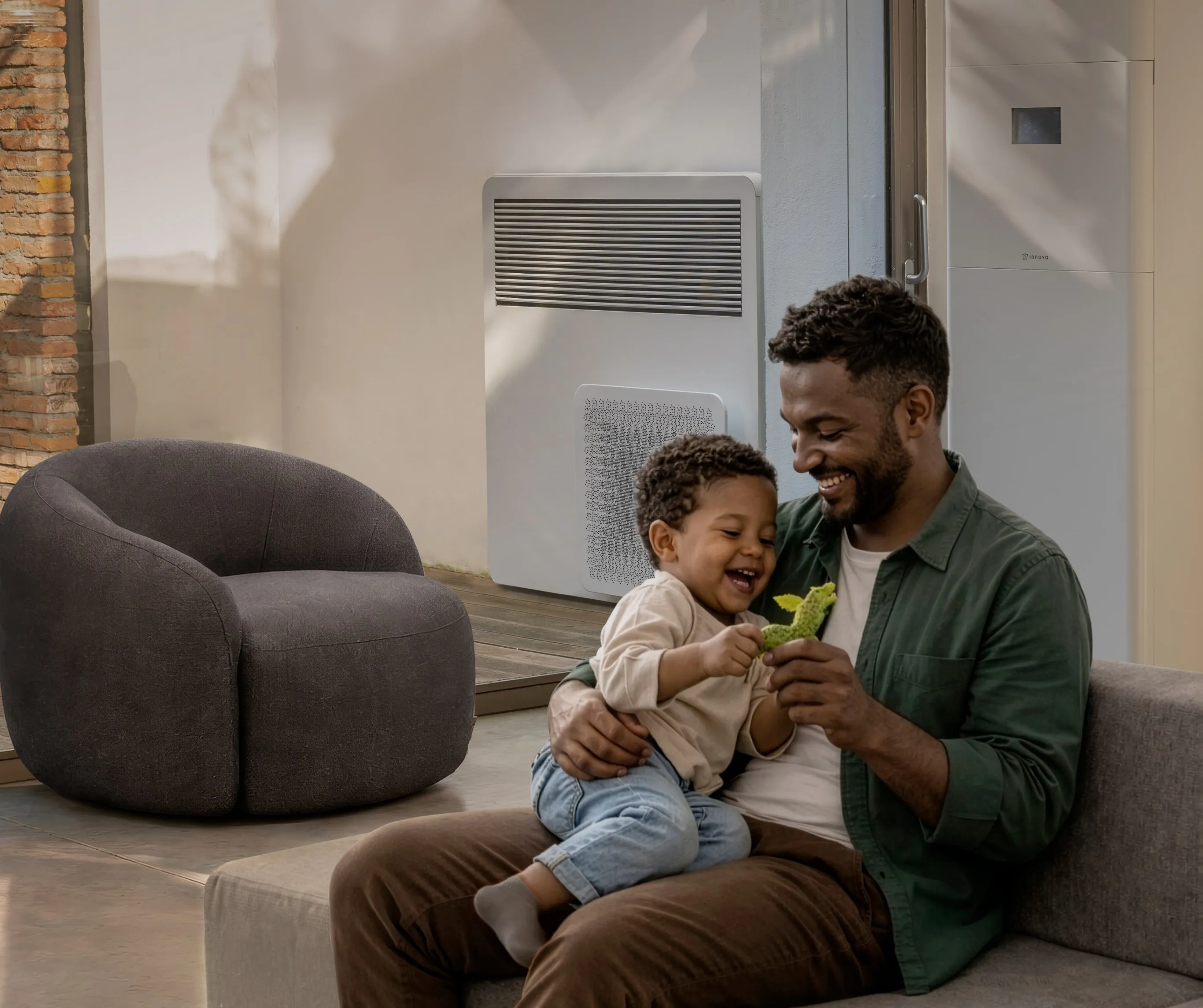 A father and child on a sofa near a STØNE floor console