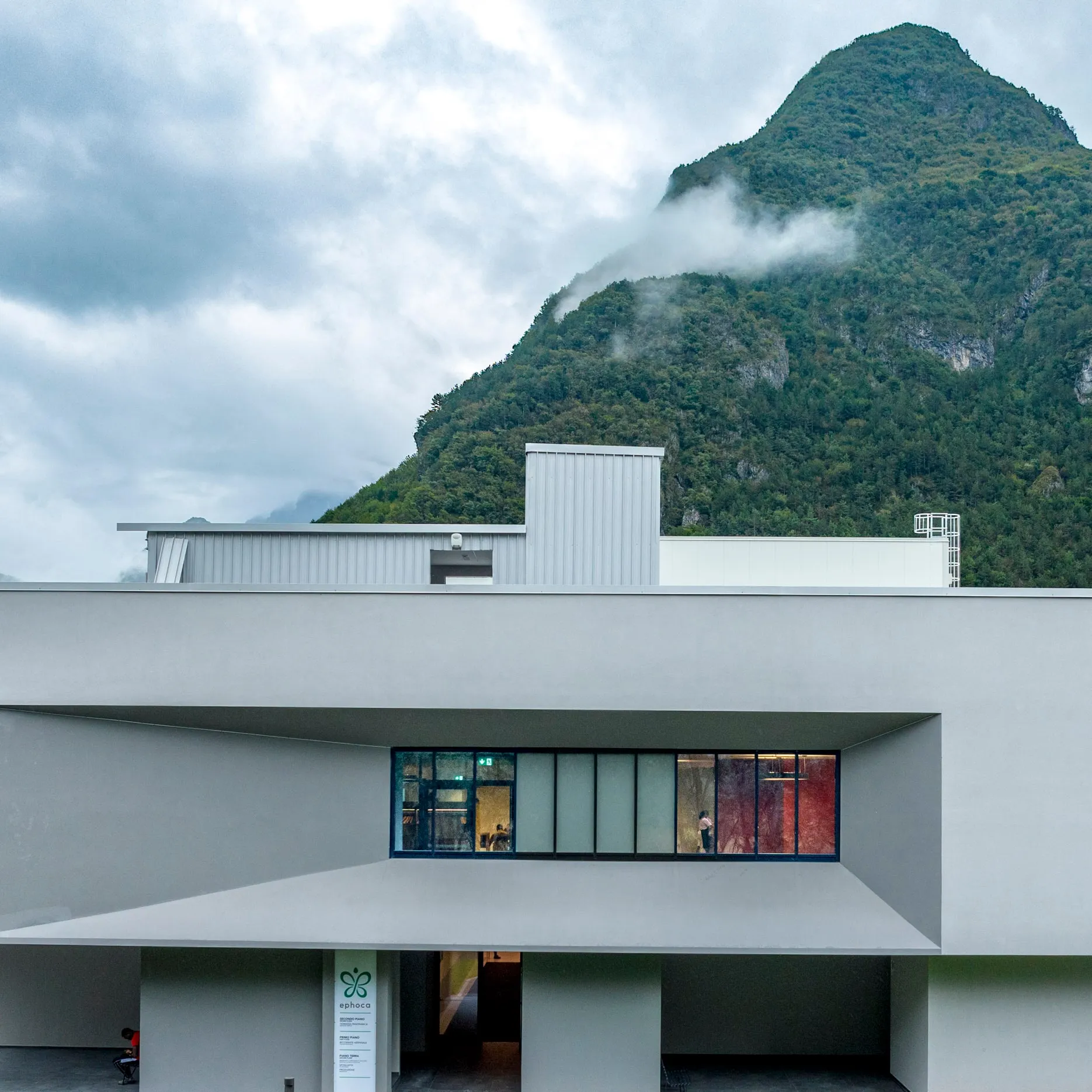 The white industrial complex against the mountains